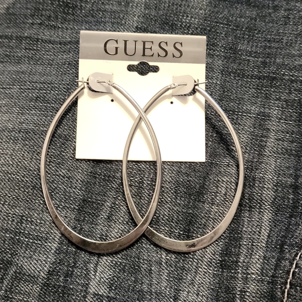 NWT Guess silver long oval hoop earrings. Never worn.